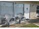 Welcoming porch with two Adirondack chairs, perfect for relaxing outdoors at 4324 Tahitian Gardens Cir # J, Holiday, FL 34691