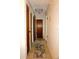 Bright hallway with tile flooring, multiple doors, and neutral wall paint at 4324 Tahitian Gardens Cir # J, Holiday, FL 34691