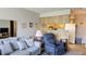 Cozy living room featuring comfortable seating, neutral decor, and a glimpse into the adjacent kitchen at 4324 Tahitian Gardens Cir # J, Holiday, FL 34691