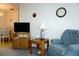 Comfortable living room featuring a cozy armchair, TV, and adjacent dining area for easy entertaining at 4324 Tahitian Gardens Cir # J, Holiday, FL 34691