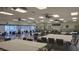 Spacious meeting room featuring tables, chairs, and ceiling fans for comfort at 4324 Tahitian Gardens Cir # J, Holiday, FL 34691