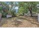 Large backyard with a storage shed and beautiful mature trees providing ample shade at 4425 W Bay Ave, Tampa, FL 33616