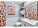 Charming bathroom featuring framed wall art, wainscoting, and a light blue color scheme at 4425 W Bay Ave, Tampa, FL 33616