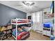 bedroom with bunk beds, shelves and a neutral gray and white wall color scheme at 4425 W Bay Ave, Tampa, FL 33616