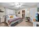 A cozy bedroom with a ceiling fan and a walk-in closet at 4425 W Bay Ave, Tampa, FL 33616