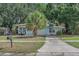 Home exterior with tidy front lawn, mature landscaping, sidewalk and ample parking at 4425 W Bay Ave, Tampa, FL 33616