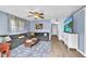 Inviting living room features a comfortable sectional sofa, wood floors and a wall-mounted TV at 4425 W Bay Ave, Tampa, FL 33616