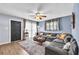 Cozy living room features a large sectional sofa, wood floors and stylish decor at 4425 W Bay Ave, Tampa, FL 33616