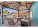 Covered patio with wicker furniture near the above ground pool at 4570 67Th N St, St Petersburg, FL 33709