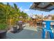 Outdoor deck space features an outdoor grill and plenty of lounge seating surrounded by mature tropical landscaping at 4570 67Th N St, St Petersburg, FL 33709