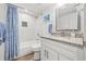 Bright bathroom with white cabinets, granite counters, shower, and nautical themed decor at 4570 67Th N St, St Petersburg, FL 33709