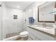 Updated bathroom featuring a tiled walk-in shower and granite vanity at 4570 67Th N St, St Petersburg, FL 33709
