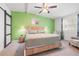 Bedroom with unique rope accents, ceiling fan, barn door and bright green accent wall at 4570 67Th N St, St Petersburg, FL 33709