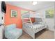 Bright bedroom features a bunk bed, a window, and a chair at 4570 67Th N St, St Petersburg, FL 33709