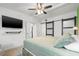 Bright bedroom with tv, ceiling fan, and adjacent bathroom at 4570 67Th N St, St Petersburg, FL 33709