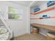 This bedroom features a built-in desk space with a window and whimsical fish art at 4570 67Th N St, St Petersburg, FL 33709