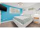 Bright bedroom with blue accent wall, white furniture, and ample natural light at 4570 67Th N St, St Petersburg, FL 33709