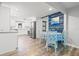 Bright dining area with a table and seating for four, flowing into a modern, white kitchen at 4570 67Th N St, St Petersburg, FL 33709