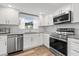 Bright kitchen with white cabinets, granite counters, stainless steel appliances and wood flooring at 4570 67Th N St, St Petersburg, FL 33709
