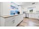 Stylish kitchen featuring white cabinets, stainless steel appliances, and a sleek countertop coffee bar at 4570 67Th N St, St Petersburg, FL 33709