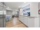 Bright, open kitchen featuring white cabinets and a stylish coffee bar, leading into the living area at 4570 67Th N St, St Petersburg, FL 33709