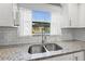 Kitchen sink with granite countertops and white cabinets, overlooking outdoor pool and covered patio at 4570 67Th N St, St Petersburg, FL 33709