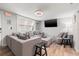 Comfortable living room featuring a sectional sofa, TV, and laminate flooring at 4570 67Th N St, St Petersburg, FL 33709
