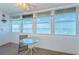 Inviting sunroom featuring large windows with water views and a table and chairs for enjoying the scenery at 4750 Cove Cir # 1001, St Petersburg, FL 33708