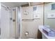 Bright bathroom with a tiled shower, towel bar, neutral wall color, and decorative mermaid statue at 4750 Cove Cir # 1001, St Petersburg, FL 33708