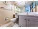 Bathroom featuring a white toilet, a vanity, and neutral decor to create a cozy and functional space at 4750 Cove Cir # 1001, St Petersburg, FL 33708