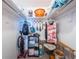 Organized closet with shelves, hanging storage, cleaning supplies, and personal items at 4750 Cove Cir # 1001, St Petersburg, FL 33708
