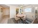 Bright dining area with tile flooring, a window providing natural light, and seating for four at 4750 Cove Cir # 1001, St Petersburg, FL 33708