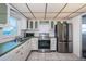 Well-equipped kitchen featuring stainless steel appliances and white cabinets with green trim at 4750 Cove Cir # 1001, St Petersburg, FL 33708