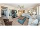 Inviting living room featuring plush sofas, built-in shelving, and a mounted TV for relaxing evenings at 4750 Cove Cir # 1001, St Petersburg, FL 33708