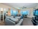 Comfortable living room with ocean views, two sofas, ceiling fan and entertainment center at 4750 Cove Cir # 1001, St Petersburg, FL 33708