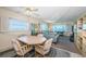 Open living area with dining table, comfortable sofa, and expansive views of the water at 4750 Cove Cir # 1001, St Petersburg, FL 33708