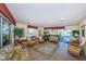 Inviting lobby with comfortable wicker furniture, plants and large windows offering views of the outside at 4750 Cove Cir # 1001, St Petersburg, FL 33708