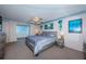 Serene main bedroom with neutral tones, balcony access, and picturesque water views at 4750 Cove Cir # 1001, St Petersburg, FL 33708