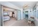 Bright sun room with glass table and ocean views, adjoining bedroom with sliding door at 4750 Cove Cir # 1001, St Petersburg, FL 33708