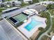 Aerial view of the community pool, shuffleboard courts, clubhouse, and parking at 4812 Jasper Dr # 203, New Port Richey, FL 34652