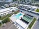 Aerial view showcasing the community pool and shuffleboard courts alongside well-maintained residential buildings at 4812 Jasper Dr # 203, New Port Richey, FL 34652