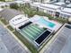 An aerial view showcases the community pool, shuffleboard courts, and clubhouse at 4812 Jasper Dr # 203, New Port Richey, FL 34652