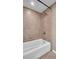 Clean bathroom showing the shower with updated hardware and a large soaking tub, ideal for relaxation at 4812 Jasper Dr # 203, New Port Richey, FL 34652