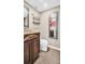 Elegant bathroom featuring ornate cabinetry and a decorative mirror that adds a touch of sophistication at 4812 Jasper Dr # 203, New Port Richey, FL 34652