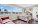 Bright bedroom with large windows offering scenic views and comfortable furnishings at 4812 Jasper Dr # 203, New Port Richey, FL 34652