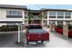 Exterior shot of the community building with parking and walkway at 4812 Jasper Dr # 203, New Port Richey, FL 34652