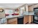 Open kitchen with a dishwasher, and a view into the living room space at 4812 Jasper Dr # 203, New Port Richey, FL 34652