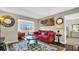 Inviting living room with a plush red sofa and a stylish round coffee table at 4812 Jasper Dr # 203, New Port Richey, FL 34652