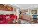 Comfortable living room with a view of the adjacent kitchen and a vibrant painting at 4812 Jasper Dr # 203, New Port Richey, FL 34652