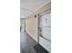 Outdoor view of the porch and exterior wall with a glass-paneled front door at 4812 Jasper Dr # 203, New Port Richey, FL 34652